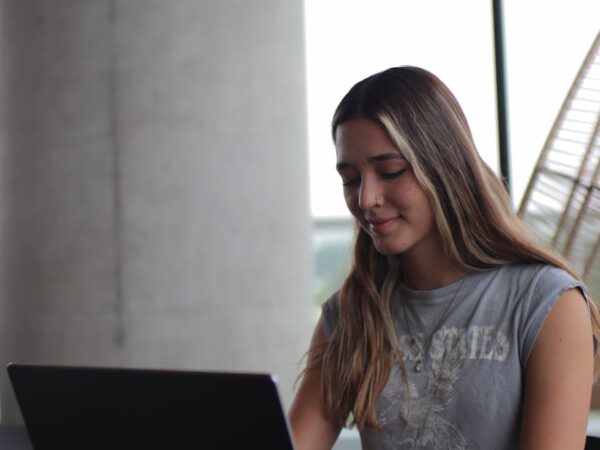a woman sitting at a table with a laptop